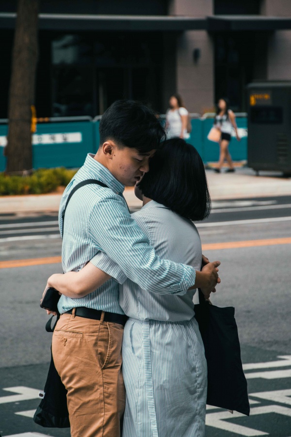Ragazzo e ragazza si abbracciano per strada a Seoul, Corea del Sud